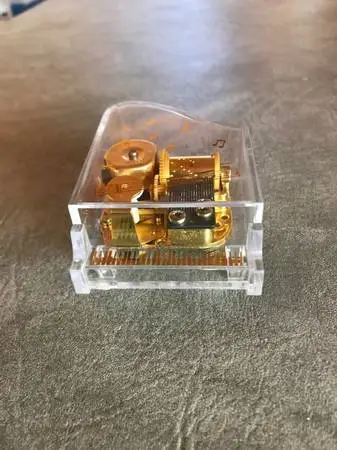 Acrylic tiny musical piano plays Memory