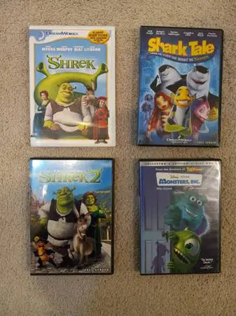 4 DVDS - Shrek, Shrek 2, Shark Tale, Monsters Inc.