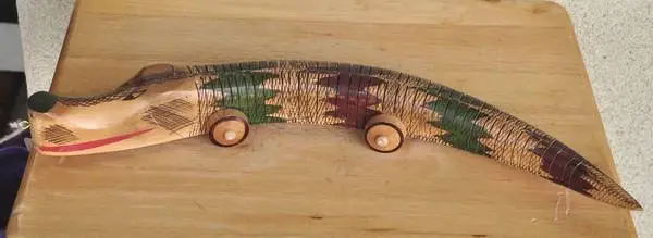 Psikhelekedana carving from Maputo Mozambique depicting snake on wheel