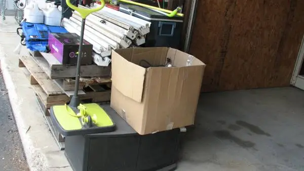 Pile of stuff, light fixtures, stadium seat, TV Stand, DEF, old cooler