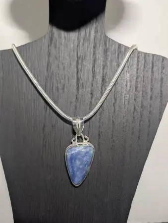 Beautiful blue dumortierite pendant on a marked 925 sterling silver chain.