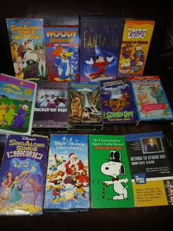 Variety of vintage CDs & VHS tapes.