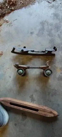 One vintage steel wheel roller skate and one clip-on vintage ice skate