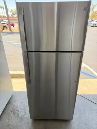 GE brand apartment size refrigerator and top freezer