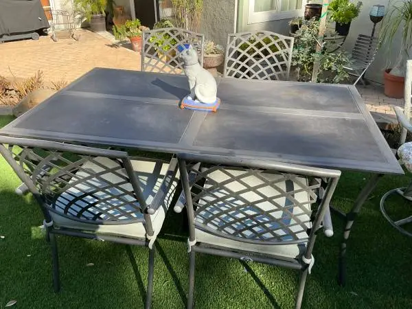 Metal top patio set with 4 chairs and cushions