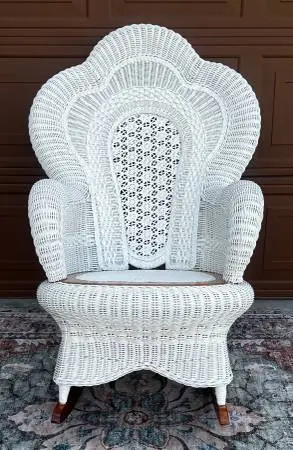 White painted wicker rocking chair with ornate scalloped fan back
