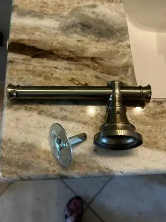 Brushed nickel Delta toilet paper holder with pivoting arm