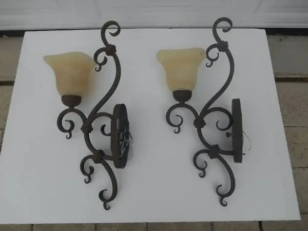 Pair of ornate bronze metal wall sconces
