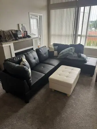 Black leather sectional couch and ottoman