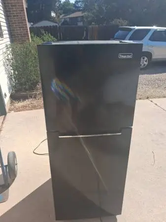 Apartment size black refrigerator