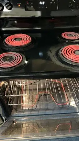 Black refrigerator and electric stove