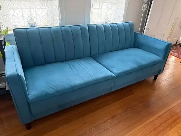 Teal blue tufted futon
