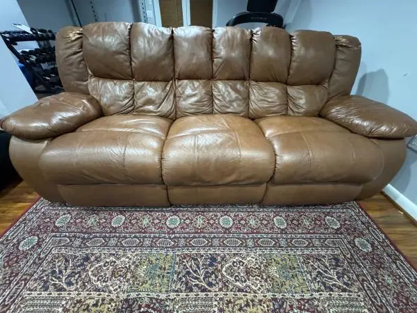 Old leather couch with manual recliners