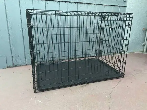 Sturdy black wire dog crate. Has a removable plastic tray.