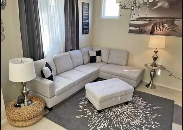 Gray linen sectional couch and ottoman