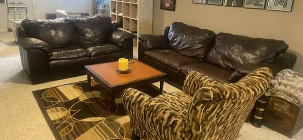 Two couches, table, chair, and rug