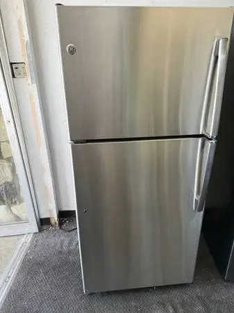 GE brand apartment size refrigerator and top freezer