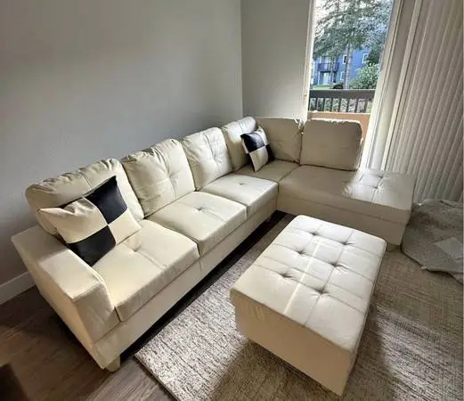 White leather sectional couch and storage ottoman