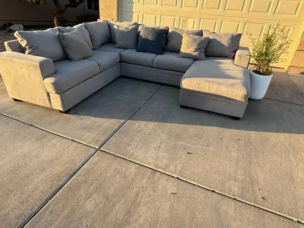 GREY REVERSIBLE CHAISE SECTIONAL BY LIVING SPACES , DELIVERY INCLUDED