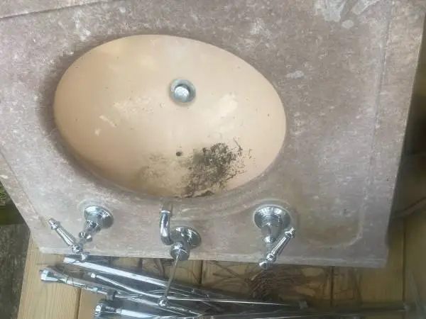 Marble bathroom sink with a 30” backsplash and faucet