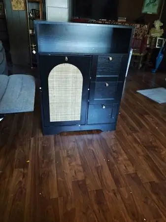 Storage cabinet with tiltable trash liner