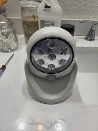 Versatile white plastic motion-activated light with seven LED bulbs. This unit h