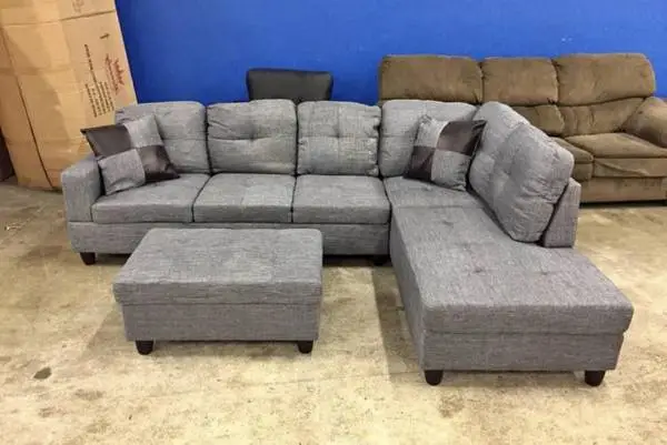 Gray linen sectional couch and ottoman