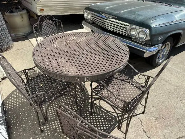 Vintage Metal patio table with four chairs. Will deliver