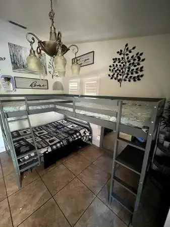 Near new wood framed corner triple bunk bed with desk