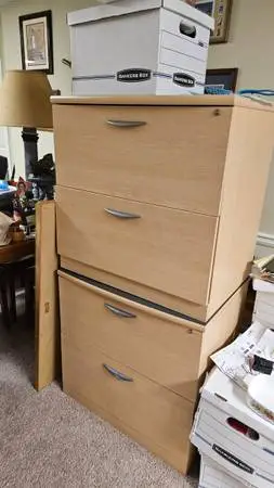 Two filing cabinets both with two drawers and desk chair