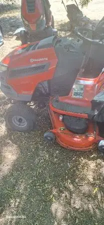 riding lawn mowers lots of Husqvarnas and john deere