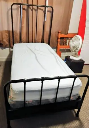 Beautiful black metal twin size bed complete with mattress and box spr
