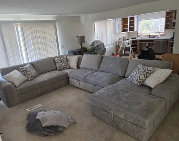 Brand new large chenille sectional couch with pull out sleeper and sto