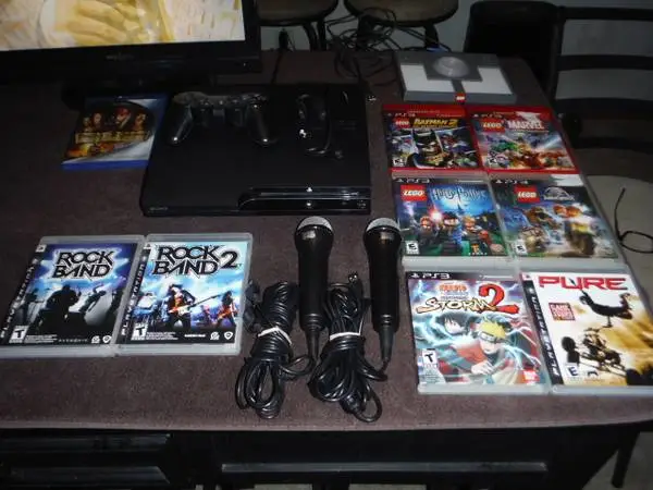 PS3 with controller, 8 games, 2 mics, lego board and charge cord
