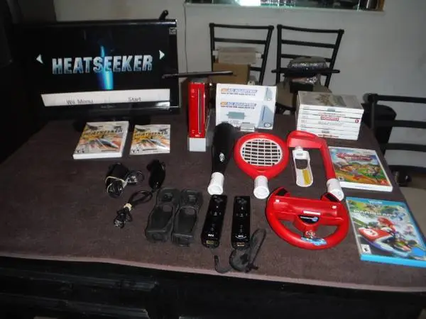 Red Wii console, 11 games/sportsgear, controls, dongles, fitness board