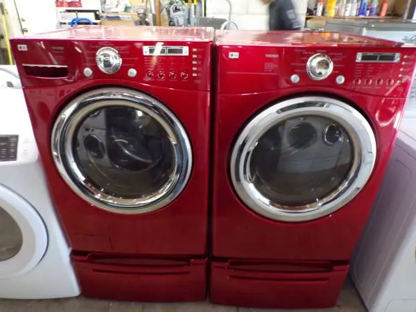 Red LG washer and dryer w/ pedestals