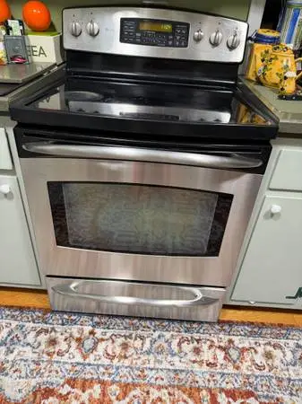 GE Profile Stainless Steel Electric range and dishwasher. LG microwave