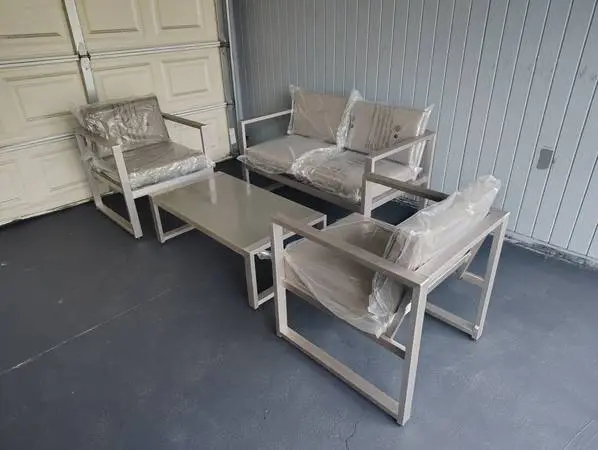 Outdoor patio couch with chairs and coffee table