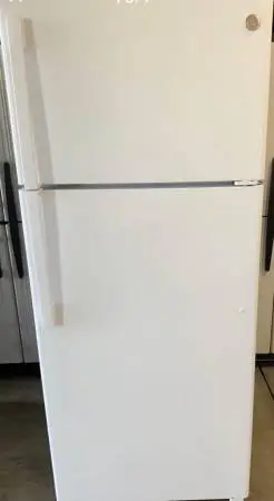 New White GE top freezer refrigerator 18 CB Ft capacity with ice maker