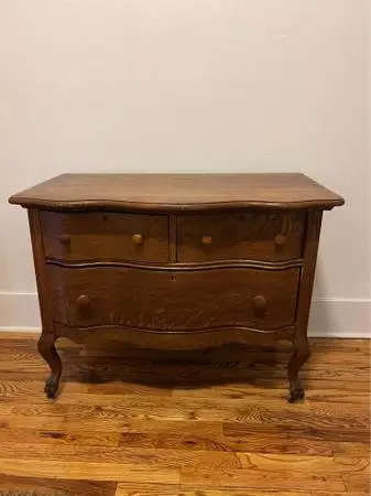 vintage wooden dresser with scalloped details