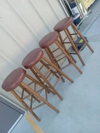 4 wood bar stools with round padded seats $ 25 each, good condition