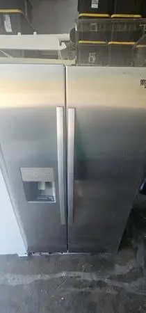 Whirlpool stainless side by side refrigerator with ice and water