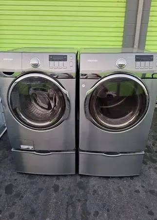 Washer and Dryer Samsung Stainless Steel On Pedestals