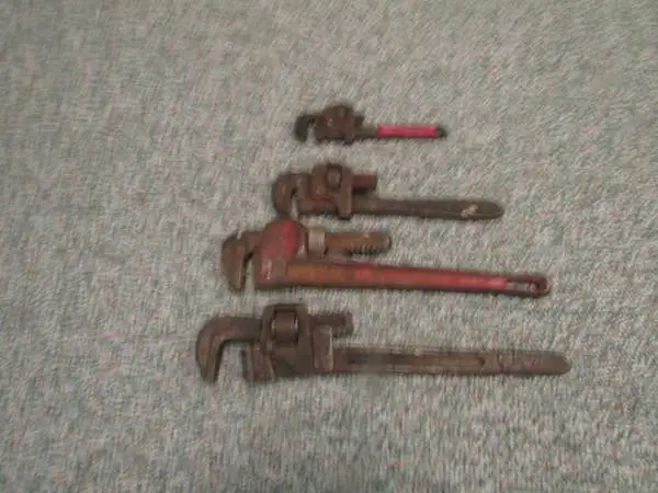 Four spare pipe wrenches