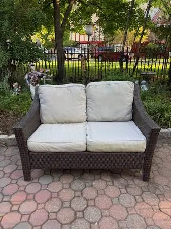 Faux wicker patio loveseat with cushions