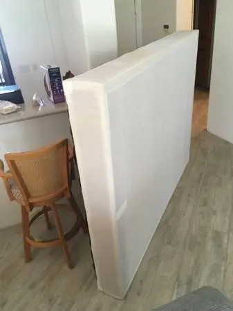 Queen size box spring and bed frame with casters.