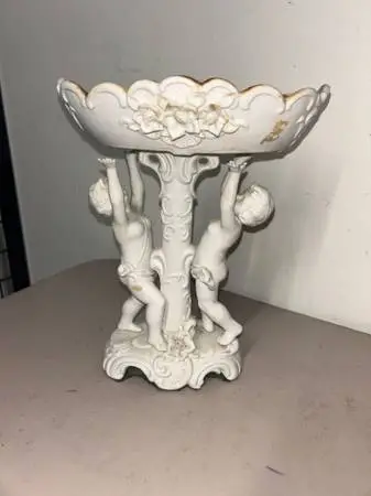 Vintage Porcelain Centerpiece Featuring Winged Cherubs holing up a sca