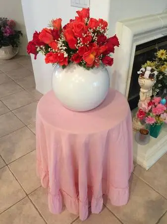Round table & pink cover.