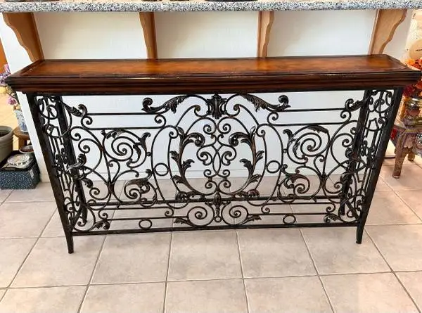 Ornate wrought iron console table.