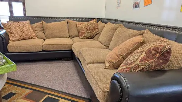 3 piece Sectional Sofa with brown leather base, studded nailhead trim